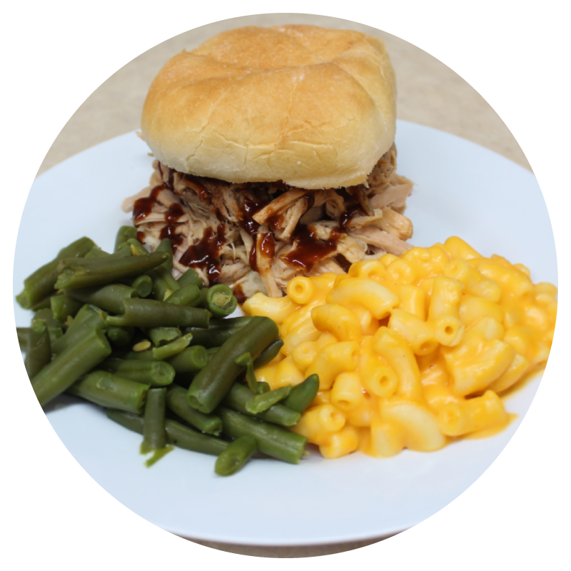 Sandwich-with-sides-in-circle Sandwich with sides, nicely presented on white plate.