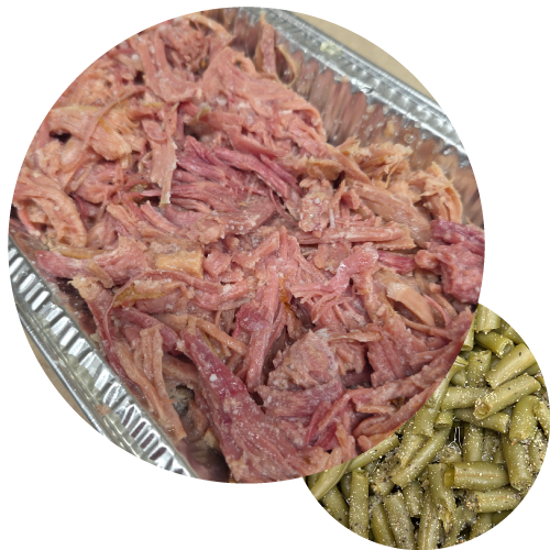 Pulled ham in pan and green beans on the side.